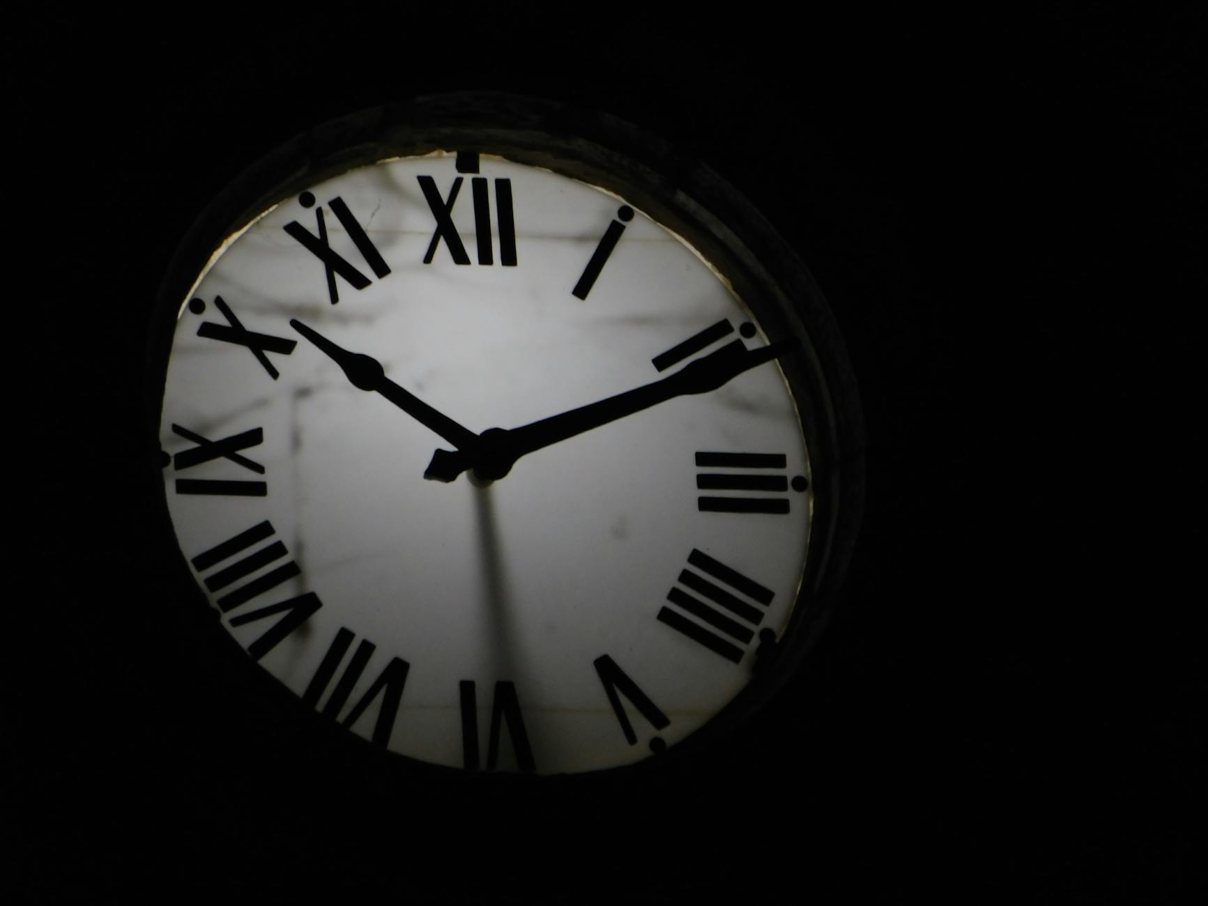 round mechanical clock on black background